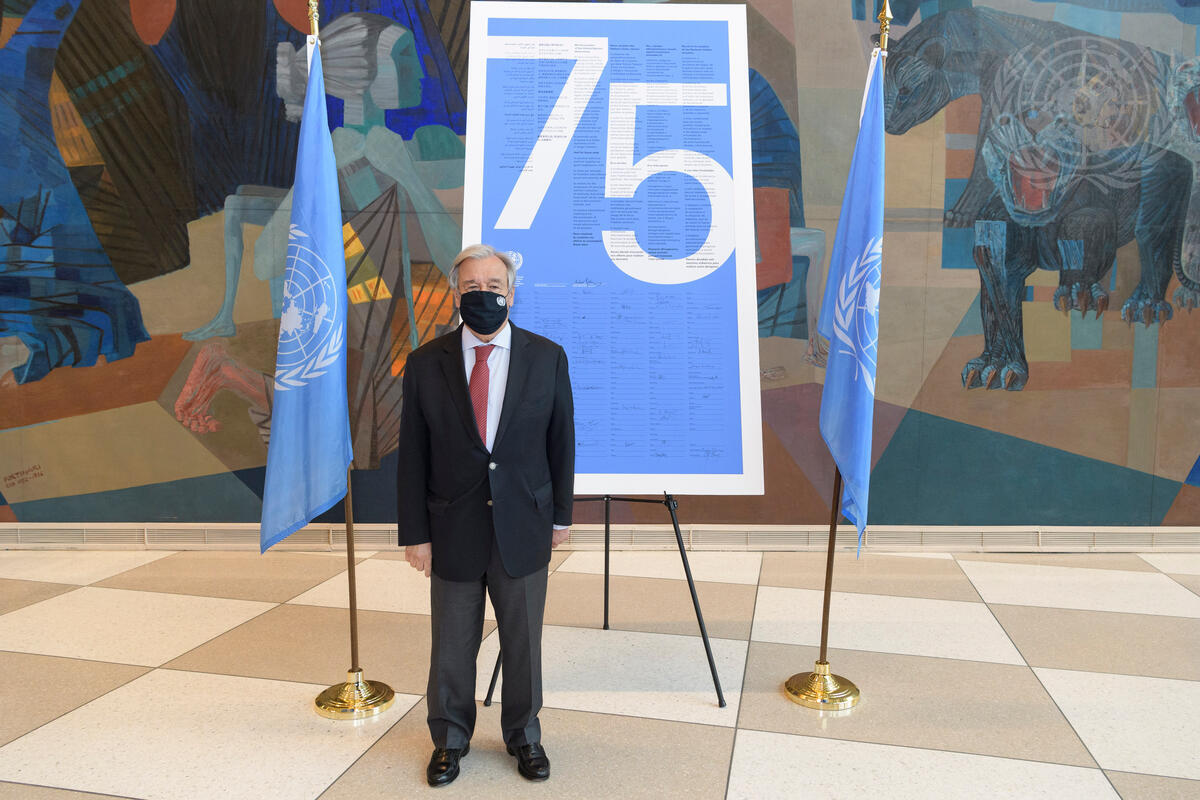 Guterres posing with UN Charter preamble